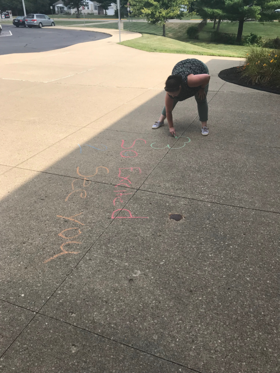 person drawing on sidewalk